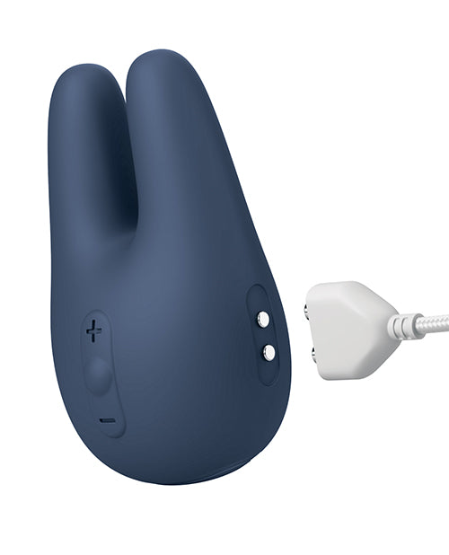 The Jimmyjane Form 2 Pro shown next to its magnetic charger with the magnetic charger about to make contact with the magnetic charging prongs on the side of the vibrator. | Kinkly Shop