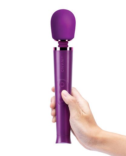A hand holds the Le Wand Petite Rechargeable in Cherry | Kinkly Shop