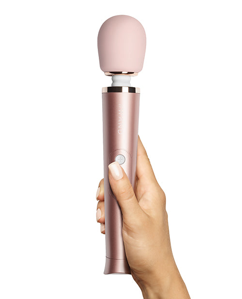 A hand holds the Le Wand Petite Rechargeable in Rose Gold | Kinkly Shop