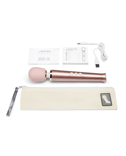 Everything included with the Le Wand Petite Rechargeable. This shows the charging cable, the guide to using the wand, the instruction booklet, the zip-up storage pouch, and the wand itself. | Kinkly Shop