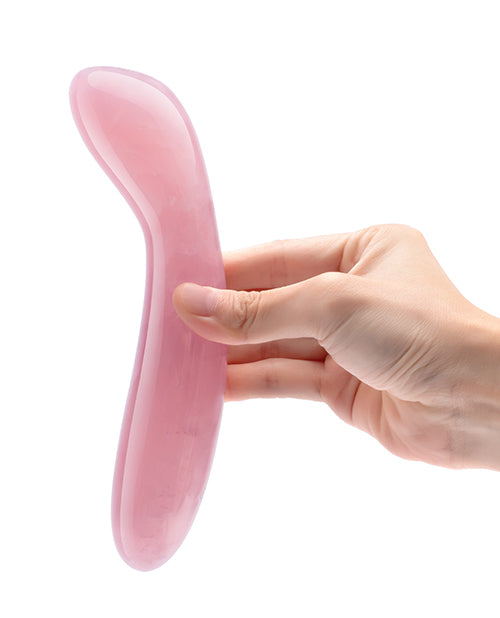A hand holds the Le Wand Crystal G, showcasing the thickness and curve of the dildo. | Kinkly Shop