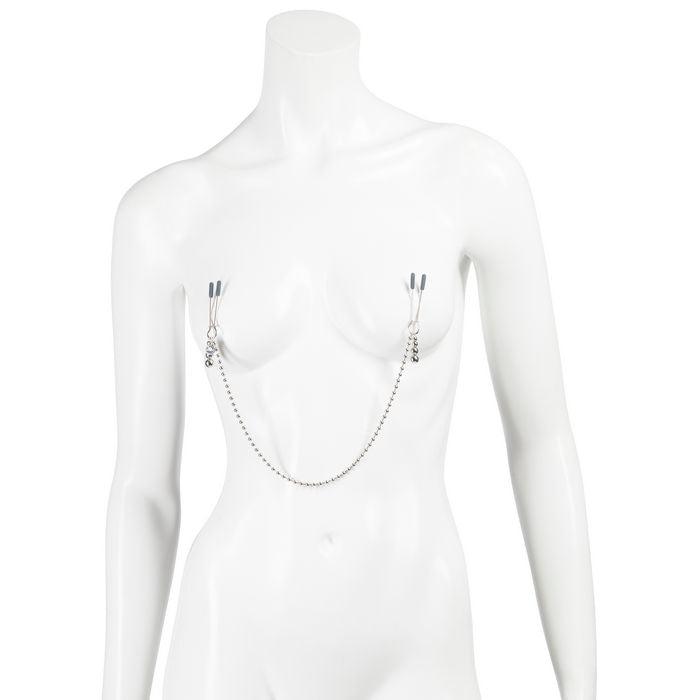 A mannequin wears the Fifty Shades "At My Mercy". A visible chain drapes between the two clamps, attaching them together. | Kinkly Shop