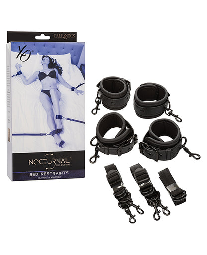 Packaging shown next to the four cuffs and tether straps that make up the Nocturnal Collection Adjustable Bed Restraints | Kinkly Shop