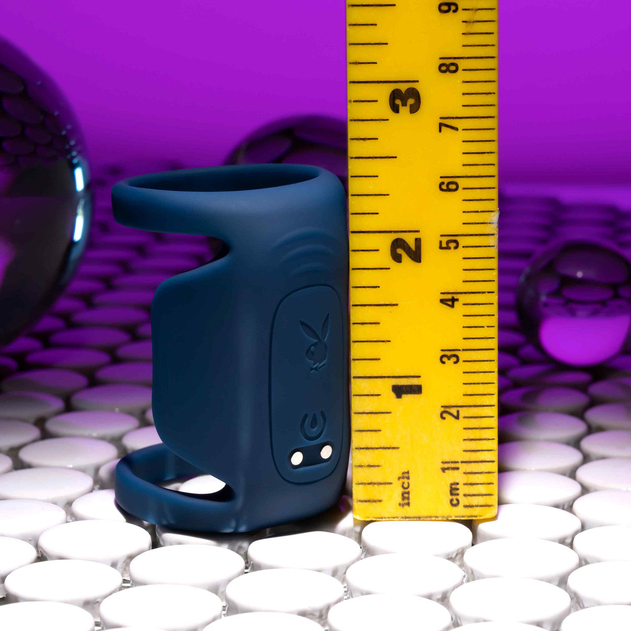 The Playboy Jet Pack sits upright next to a bright yellow measuring tape. The vibrator is 2.5" in height. | Kinkly Shop