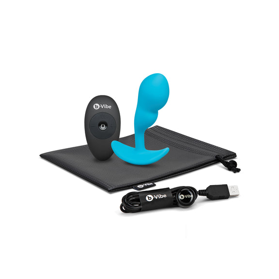 The B-Vibe Remote Control P-Spot Snug Plug and everything it comes with including a storage bag, a remote control, and the charging cable. | Kinkly Shop