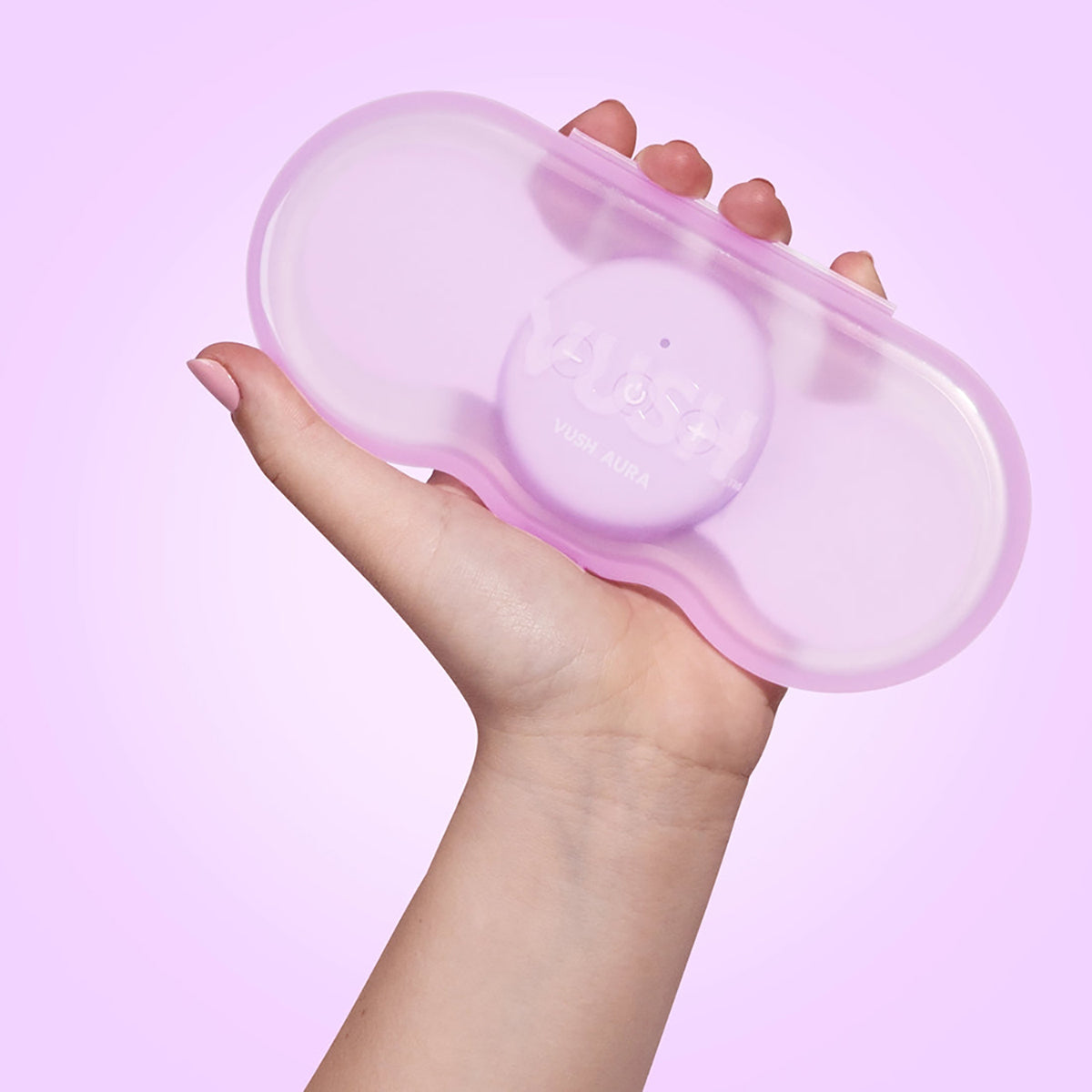 The VUSH Aura Wireless TENS Device in its case held in someone's hand. It's about the size of a cell phone. | Kinkly Shop