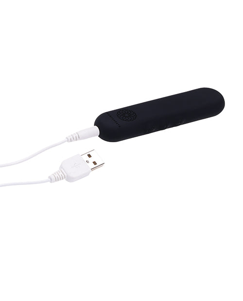 The Sportsheets Flat Bullet is plugged into its charging cable. The charging cable plug is at the base of the toy. | Kinkly Shop