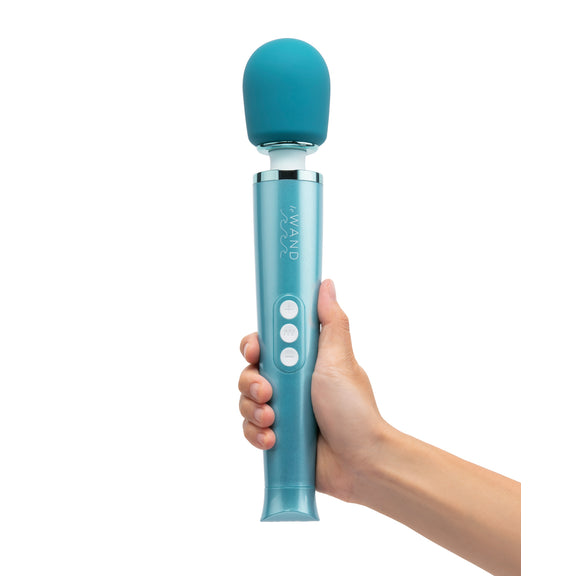 A hand holds the Le Wand Dive Waterproof Wand. It looks like a full-sized wand in their hand, a substantial toy that's in a beautiful, glittery shade of blue. | Kinkly Shop