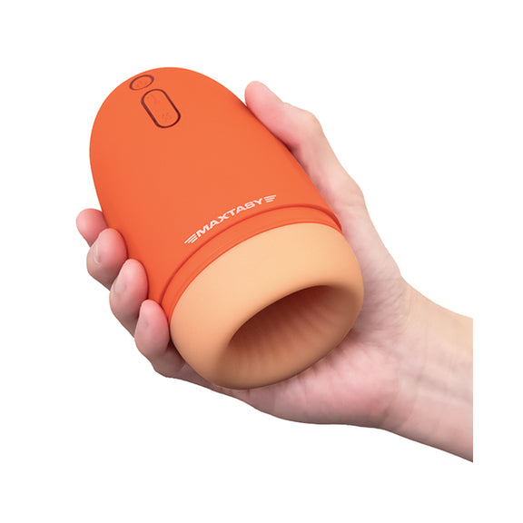 A hand holds the Maxtasy Stamina Master. It fits comfortably into their hand, slightly wider than a large plastic bottle of soda. | Kinkly Shop