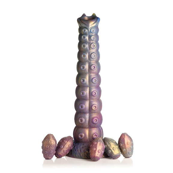 The Creature Cocks Deep Invader Ovipositor sitting upright with all of its included eggs scattered around the base | Kinkly Shop