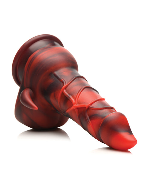 The Creature Cocks Horny Devil lays out on a table with the tear-drop shaped head pointing towards the camera. It has a large suction cup at the base. | Kinkly Shop