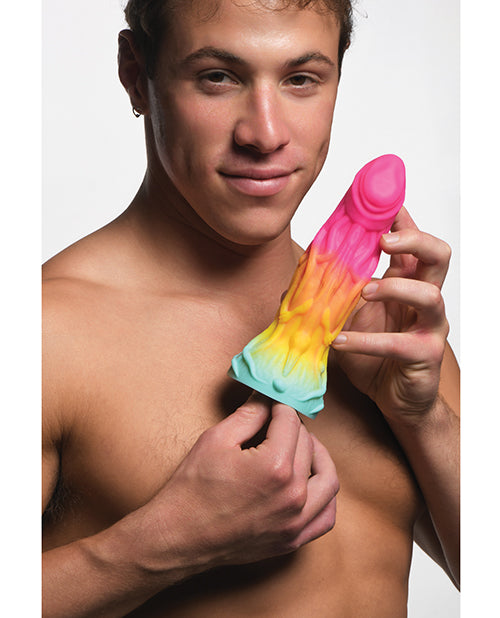 A person holds the Creature Cocks Shifter. The dildo looks about average length but very thick in their hands. | Kinkly Shop