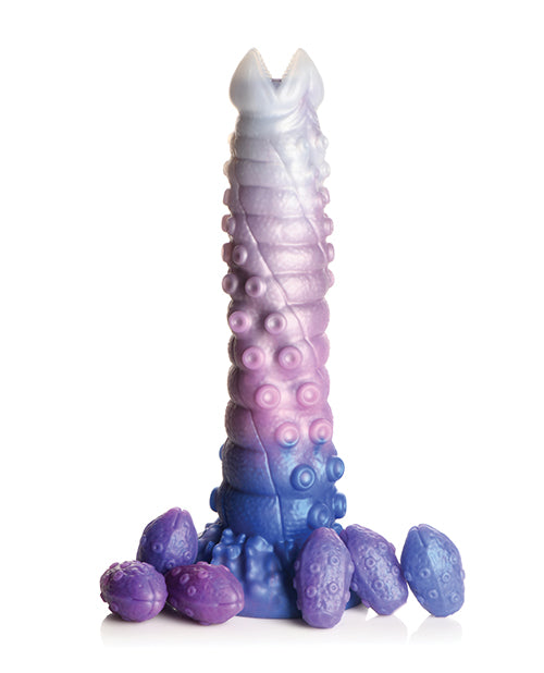 The Creature Cocks Tenta-Queen Ovipositor with all of its included silicone eggs scattered around its base. | Kinkly Shop