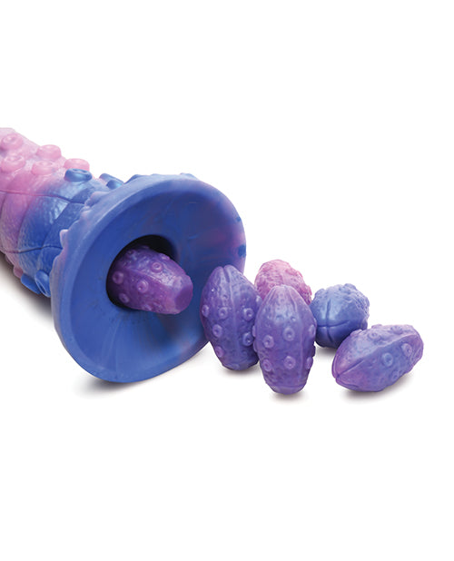 Close-up of the eggs going into the hollow tunnel base of the Creature Cocks Tenta-Queen Ovipositor. They seem to fit with a little bit of extra room to spare. | Kinkly Shop