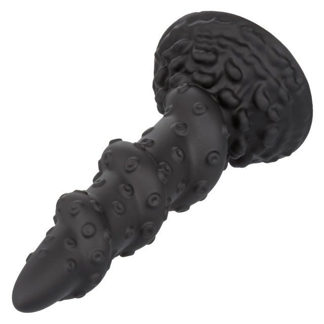 The Monster Dong Kraken lays on a flat surface. The dildo has a tapered tip and gets thicker as you go towards the base. | Kinkly Shop