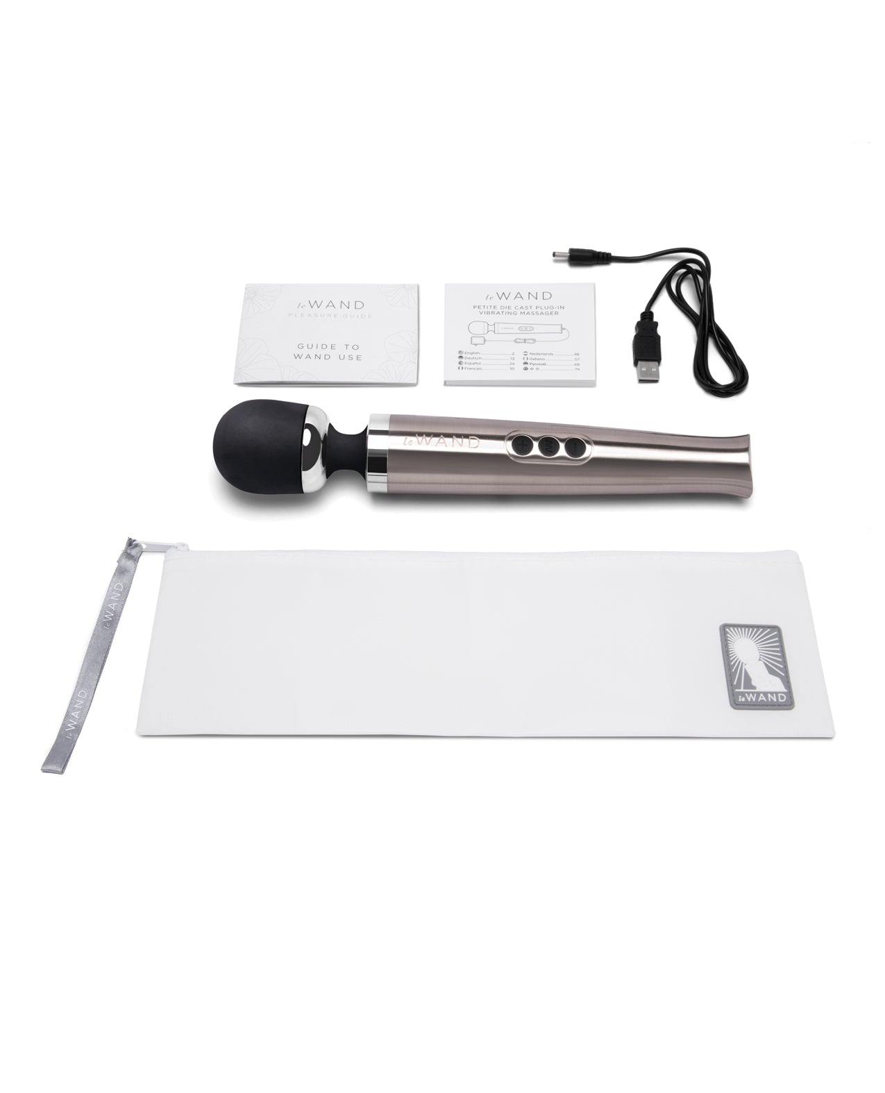 Everything that comes with the Le Wand Die Cast Rechargeable. There's the zippered storage pouch, instructions, the wand itself, and the charging cable. | Kinkly Shop