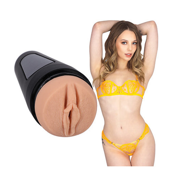 Lari in her lingerie, posing next to the stroker that's molded after her own vulva. | Kinkly Shop