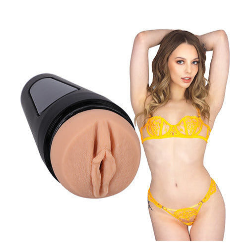 Lari in her lingerie, posing next to the stroker that's molded after her own vulva. | Kinkly Shop