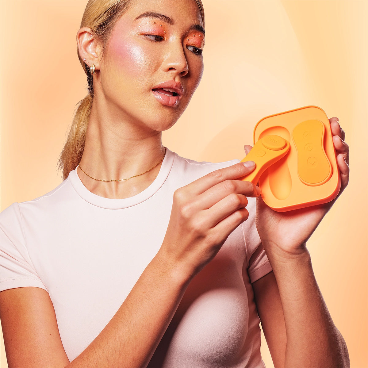 A person removes the panty vibrator of the VUSH Luna from its storage case. | Kinkly