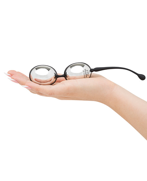 A palm is held out flat. The Inner Goddess Jiggle Balls rests in their hand. The balls are oval-shaped and look long with an average-penis thickness. | Kinkly Shop