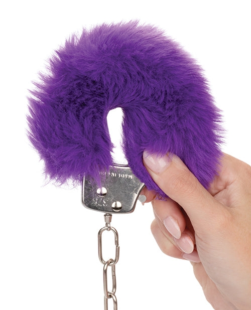 A hand holds one of the faux fur wrist cuffs up to the camera, showcasing how fluffy and soft the Ultra Fluffy Cuffs look. | Kinkly Shop