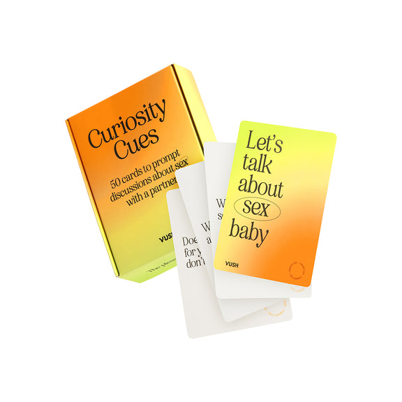 Box of the Curiosity Cues with a few of the cards open and spread out in front of the packaging. The box has an orange-to-yellow gradient. | Kinkly Shop