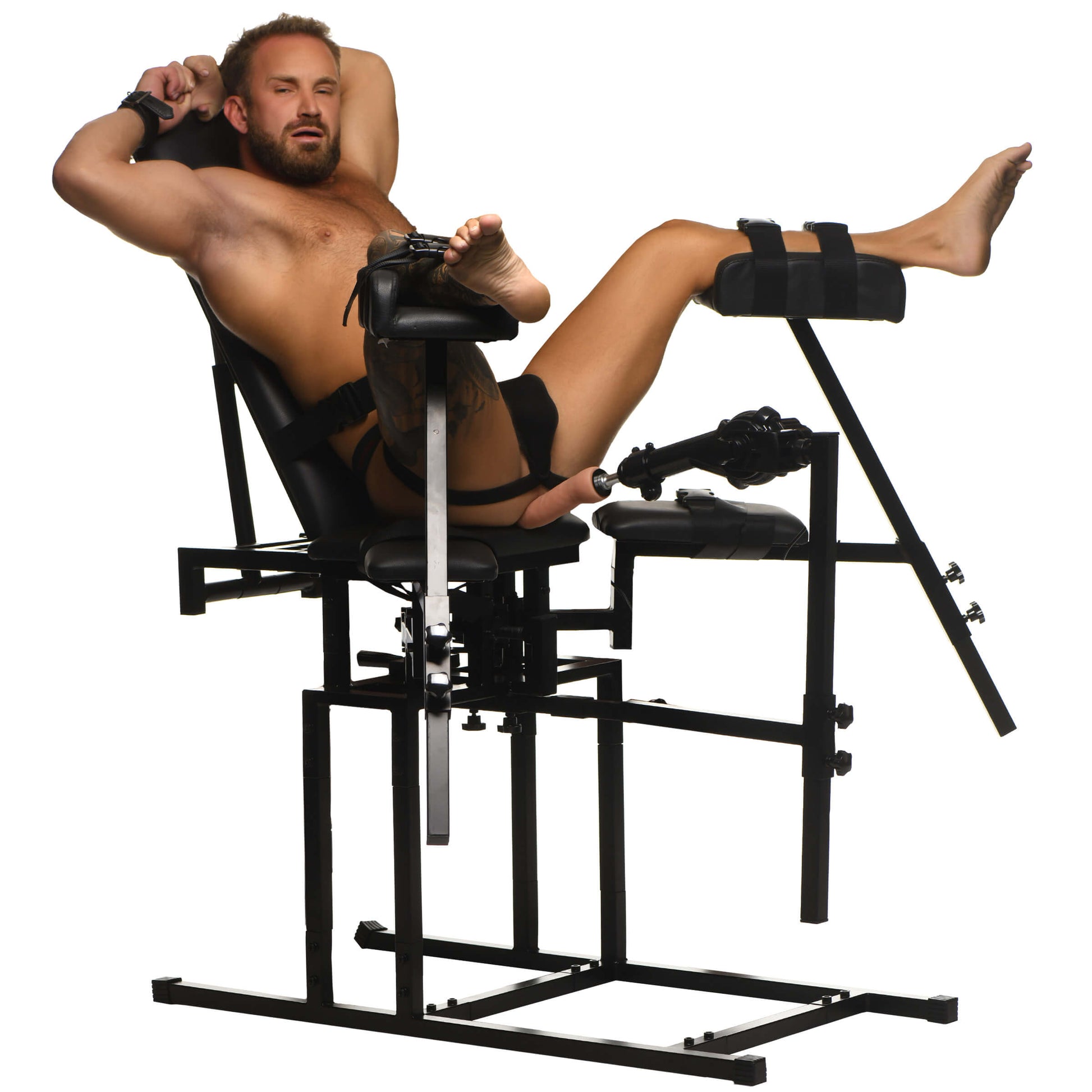 A person lounges out on the Leg Spreader Obedience Chair with Sex Machine with the sex machine positioned between their legs. Their legs are held in the calf holsters in the air. Their wrists are bound to the O-rings. Their legs and torso are strapped into the sex furniture by the built-in straps. | Kinkly Shop