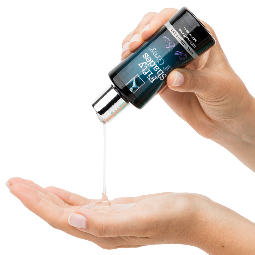 A hand pours some of the Fifty Shades of Grey at Ease into another hand. It looks like a slightly thick lubricant, making a visible pile on the palm it is being poured on. | Kinkly Shop