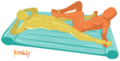 A couple is slathered in Nuru Massage Oil and laying on top of the Nuru Inflatable Massage Sheet. Both people are laying on their backs. One partner has their feet wrapped around the erection of the other and is using the slippery surface of the Nuru massage to stroke up and down. | Kinkly Shop