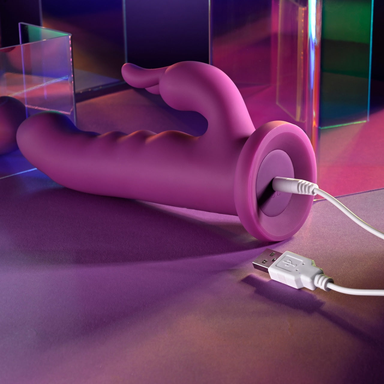 The charging cable is plugged into the base of the Playboy Fluffle. It uses a pin-style charging cable. | Kinkly Shop