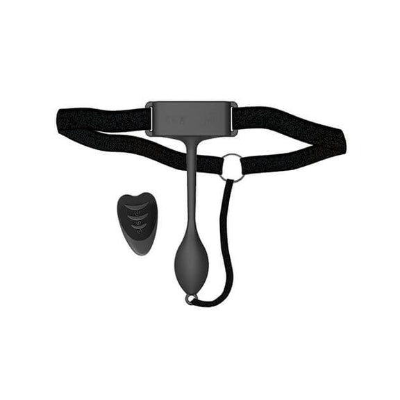 The Adrien Lastic Pan-T Vibrator shown against a white background with the vibrator and harness laid out like how they'd be worn when wrapped around someone's hips. | Kinkly Shop