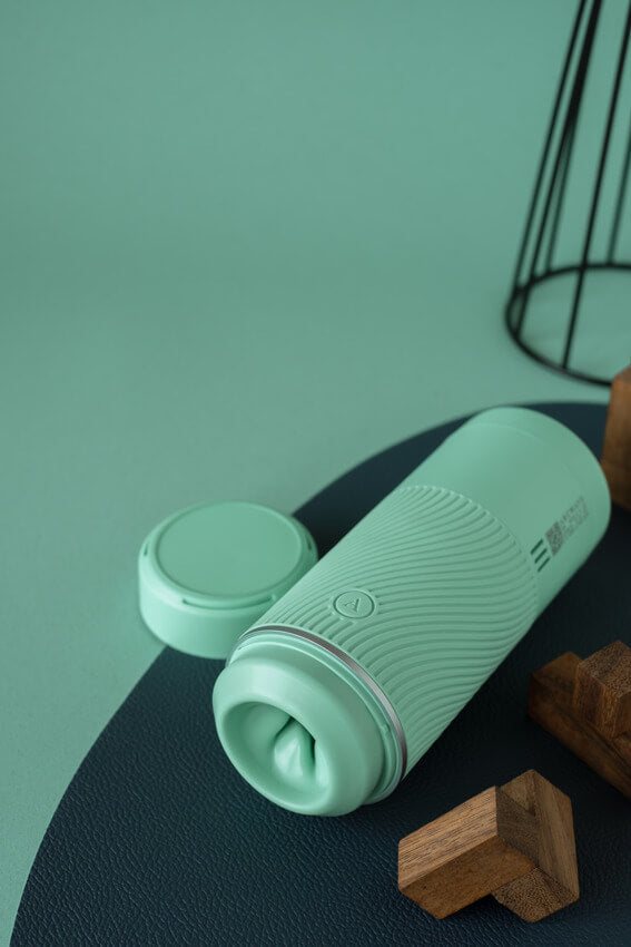 The Arcwave Pow in Mint with the lid removed. The orifice is non-realistic with a wide opening for pleasure. | Kinkly Shop