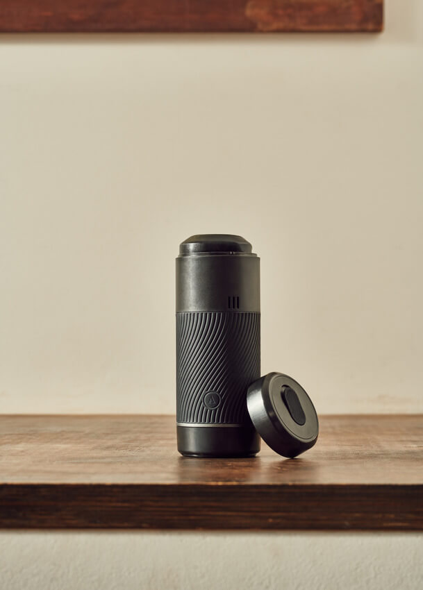 The Arcwave Pow sits out on a table with one of the lids removed. Even with the lid removed, it looks extremely discreet and it would blend in as a Bluetooth speaker sitting out on a shelf. | Kinkly Shop