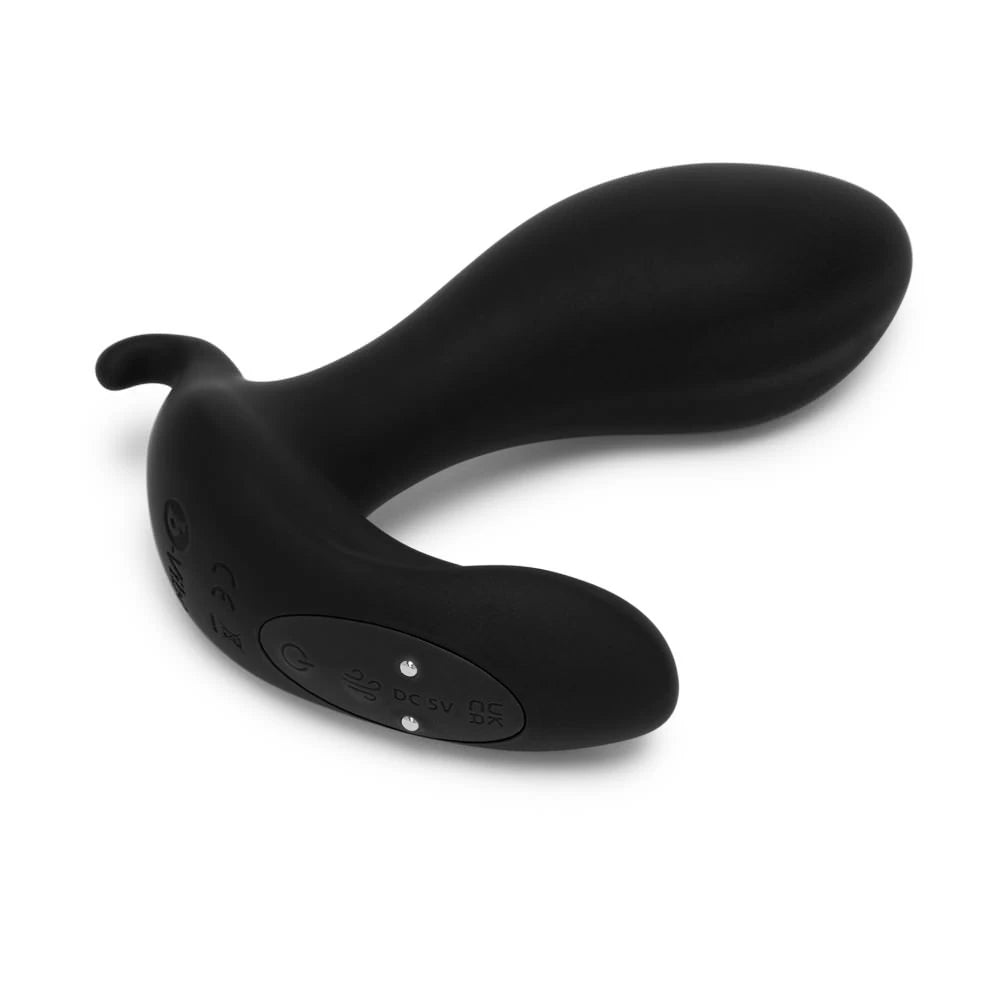 Close-up on the base of the plug, showcasing the power button, function button, and two magnetic charging prongs that charge the massager. | Kinkly