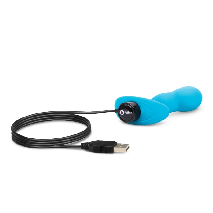 The charger plugged into the base of the B-Vibe Remote Control P-Spot Snug Plug. It's a magnetic charger that makes magnetic contact with the charging plug base. | Kinkly Shop
