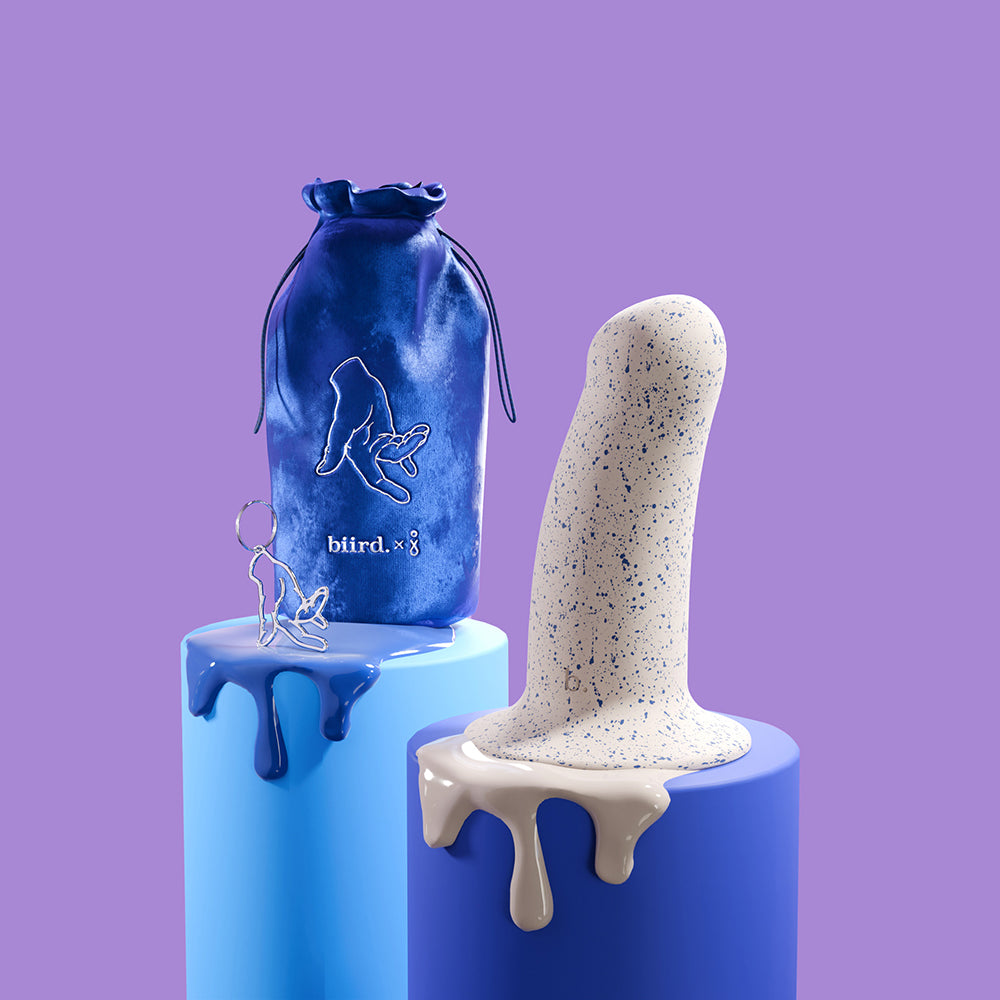 The Biird Boo next to a color-matching blue drawstring storage bag and a charmed keychain. | Kinkly Shop