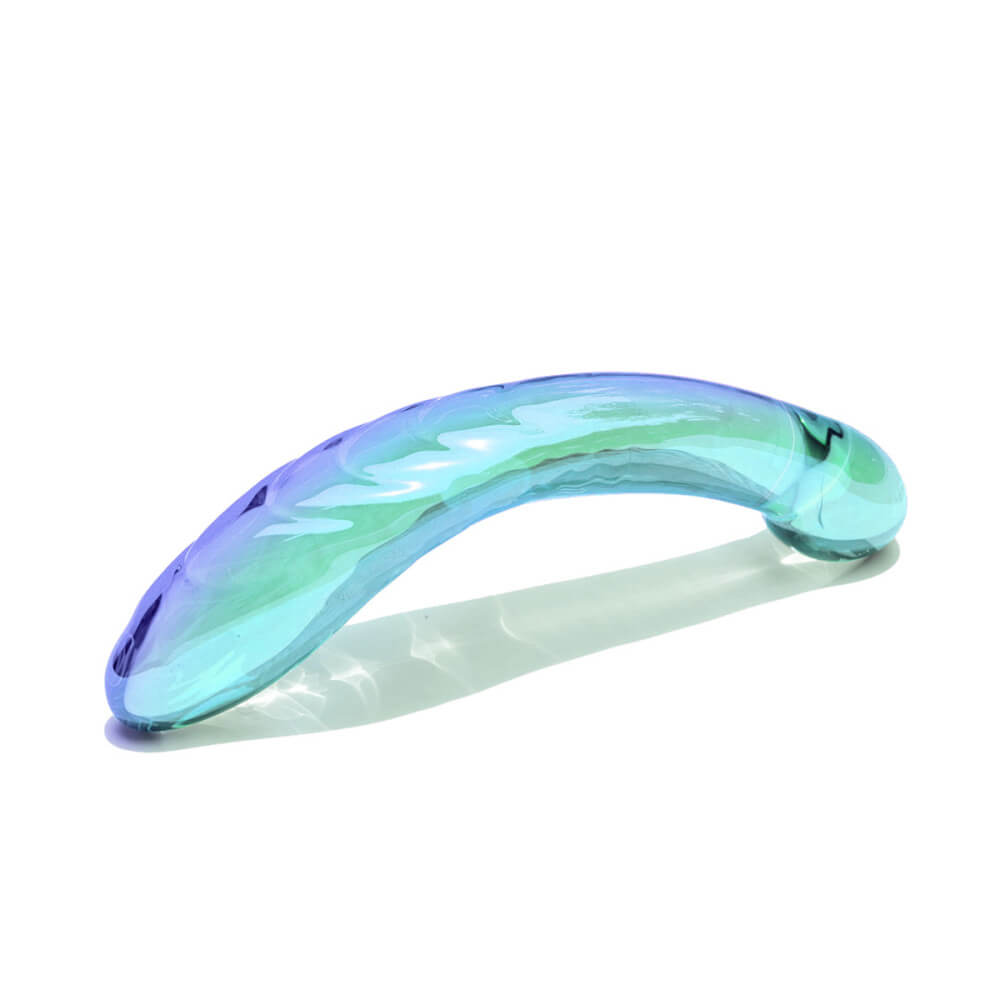 The Biird Kalii g-spot dildo facing down towards a flat surface. This showcases the curved shaft of the Biird Kalii g-spot dildo with a gentle U-shape to best hit the g-spot. | Kinkly Shop