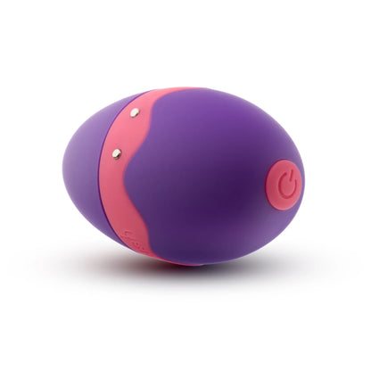 Close-up of the power button on the base of the Blush Aria Flutter Tongue as well as the two magnetic charging prongs on the side of the toy. | Kinkly Shop