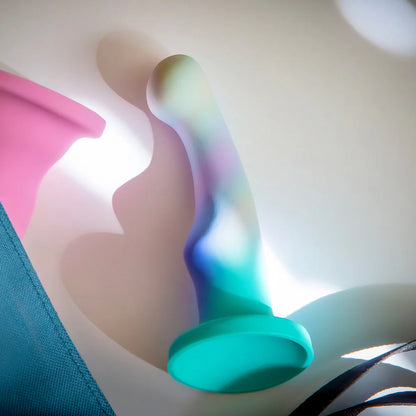 The Blush Avant Opal Dreams lays out on a desk. It has beautiful shadows around it that highlight its unique shape. | Kinkly Shop