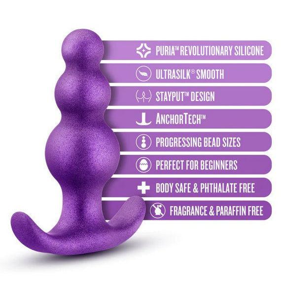 The Blush Avant Plugs in Supernova Purple shown next to a text list of features for the toy. Features include: Puria Revolutionary Silicone, Ultrasilk Smooth, Stayput Design, AnchorTech, Progressing Bead Sizes, Perfect for Beginners, Body-Safe, Phthalate-free, Fragrance and Paraffin-Free. | Kinkly Shop