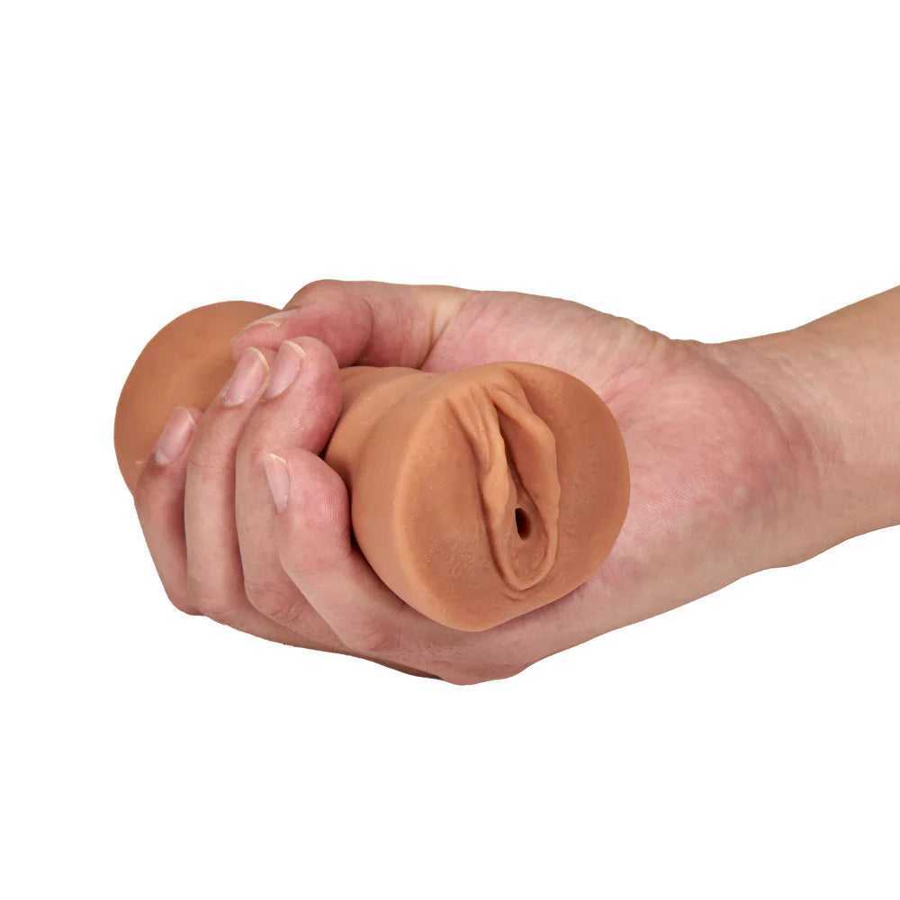 A hand holds the Blush Julieta. The stroker fits comfortably in their palm and their fingers wrap entirely around it. | Kinkly
