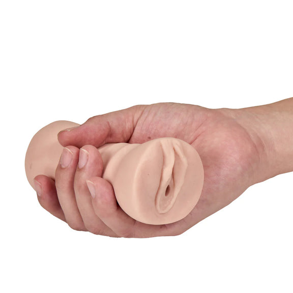 A hand holds the Blush Rain with Vibrator. The stroker looks very small and easy-to-grip in their hand. | Kinkly Shop