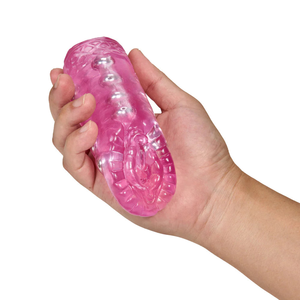 A hand holds the Blush Sexy Snatch in their hand. The stroker is about the length of the person's palm, and it looks like a very small, easy-to-grip stroker. | Kinkly Shop