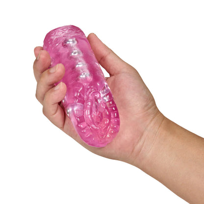 A hand holds the Blush Sexy Snatch in their hand. The stroker is about the length of the person's palm, and it looks like a very small, easy-to-grip stroker. | Kinkly Shop