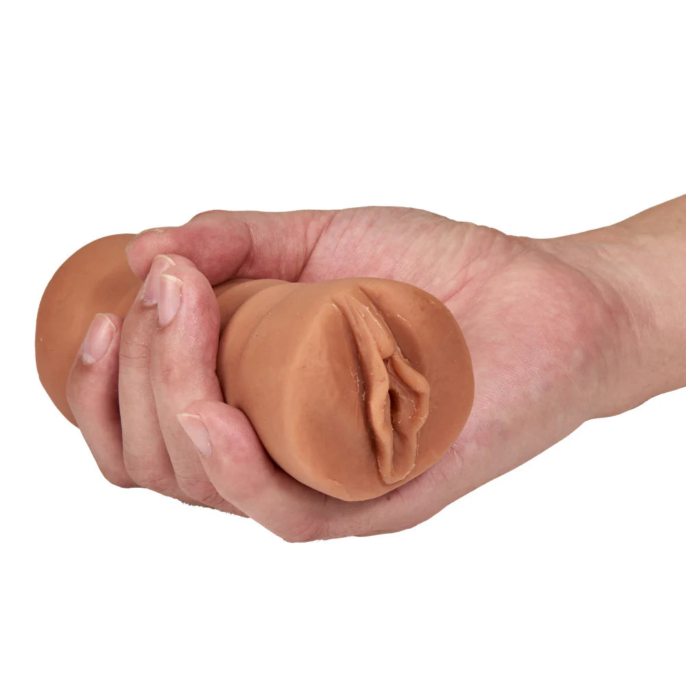 A hand holds the Sofia with Vibrator. The stroker looks small and easy to grasp within their hand. | Kinkly Shop