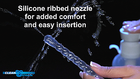 GIF is a close-up on the tip of the insertable nozzle as a person uses their fingers to press down on the enema bottle nearby. Five distinct squirts of water come from the tip. Two from each side and one from the tip. | Kinkly Shop