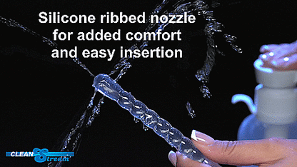 GIF is a close-up on the tip of the insertable nozzle as a person uses their fingers to press down on the enema bottle nearby. Five distinct squirts of water come from the tip. Two from each side and one from the tip. | Kinkly Shop