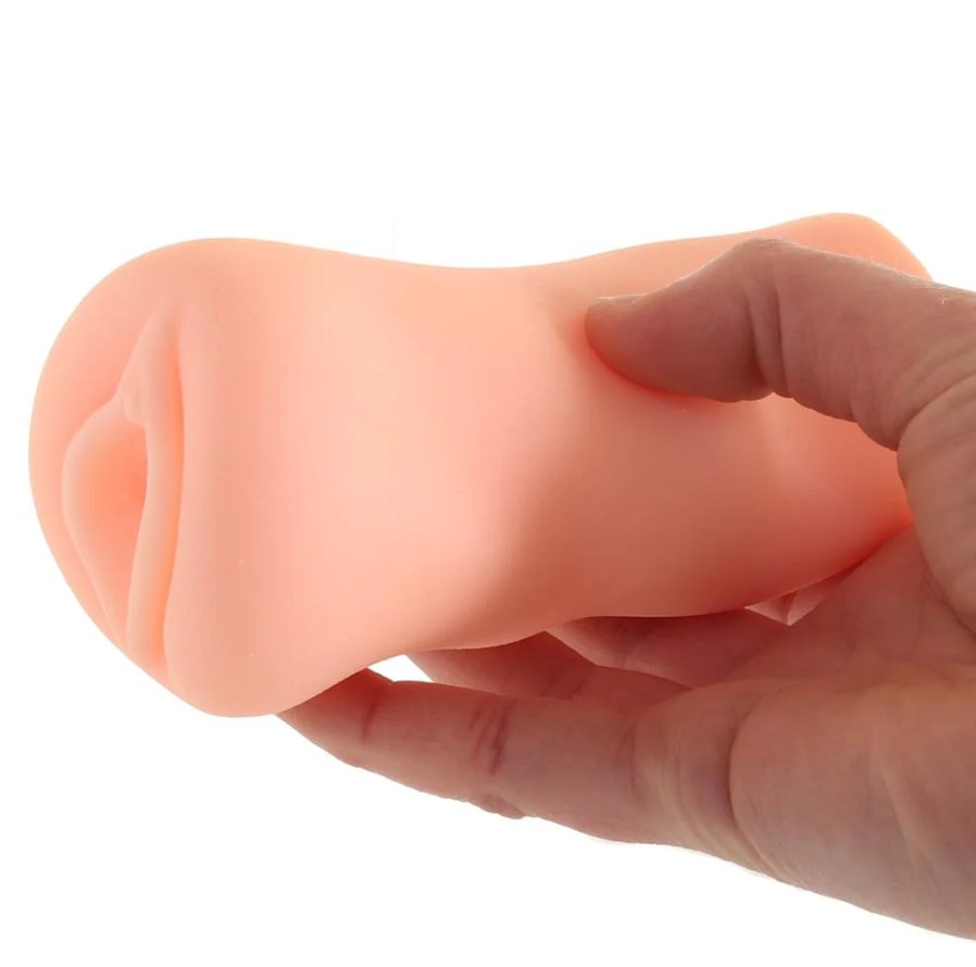 A hand holds the Alexis Adams Pussy stroker. The stroker looks small in the person's hand. | Kinkly Shop