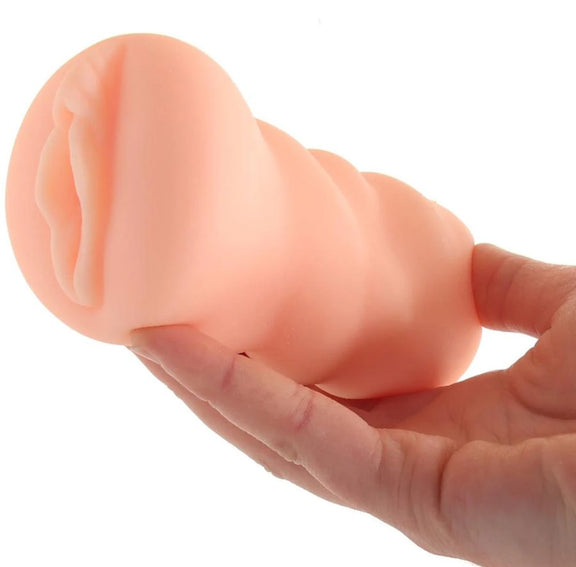 A hand holds the Brooklyn Chase Pussy stroker. It looks slender in their hand - like they could overwrap their fingers around it. | Kinkly Shop