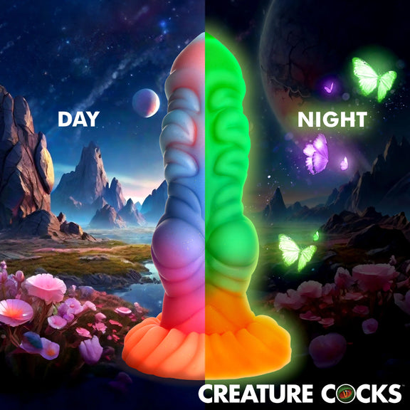 An image of the Creature Cocks Alien Invader split down the middle. On the left, it shows what the dildo looks in daylight. On the right, it showcases what the dildo looks in the glow-in-the-dark colors. | Kinkly Shop